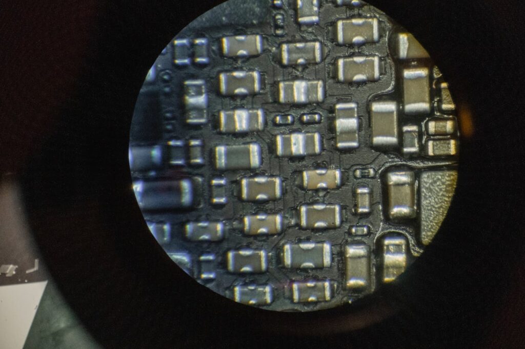 Detailed image of microchip components viewed through a microscope lens.