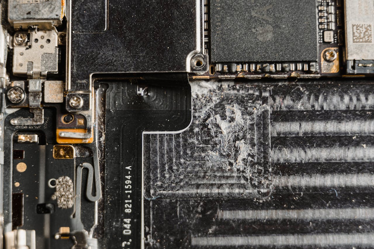 about-img Detailed close-up of a dusty mobile phone circuit board showcasing various electronic components.