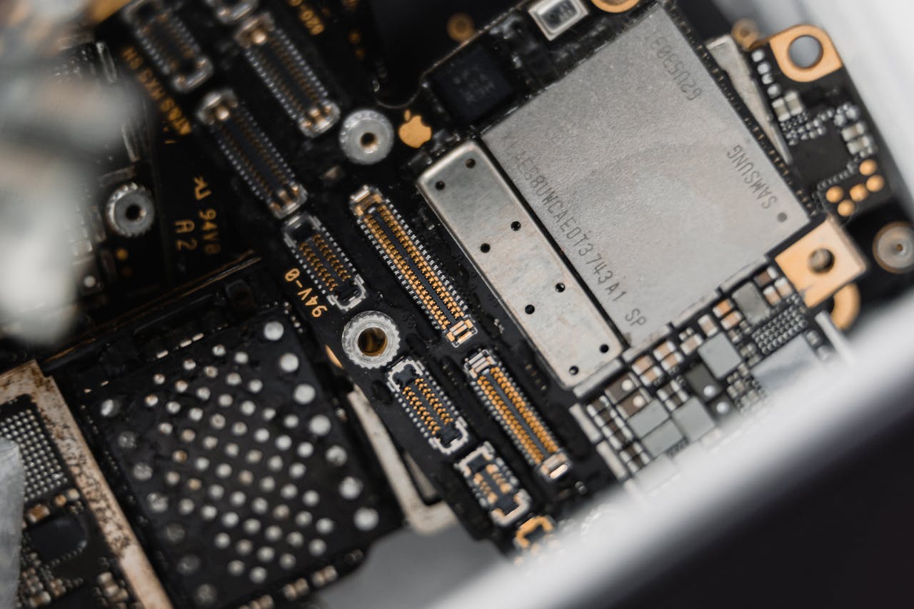 services-img Detailed view of electronic components on a circuit board for maintenance.