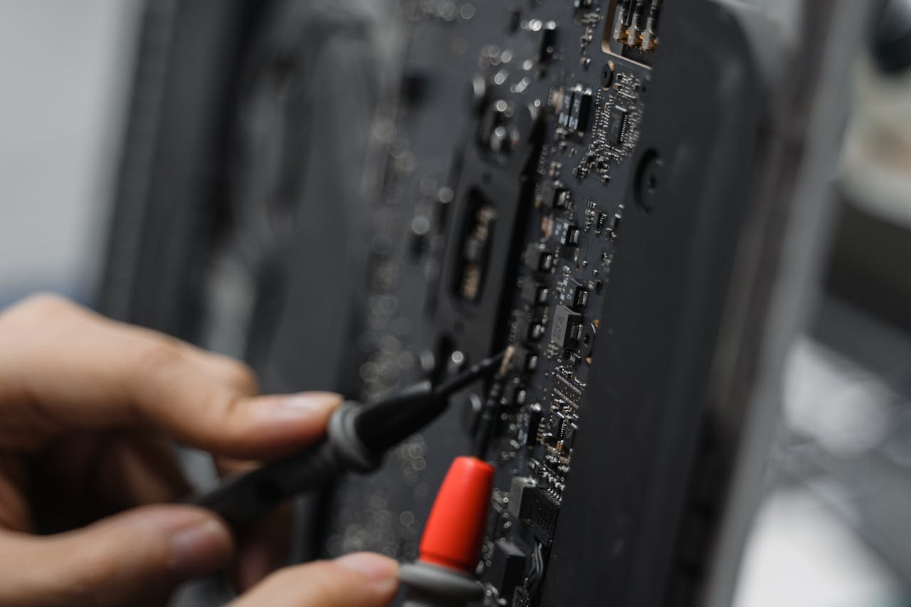 services-03 A technician uses tools to repair a circuit board, focusing on microelements.