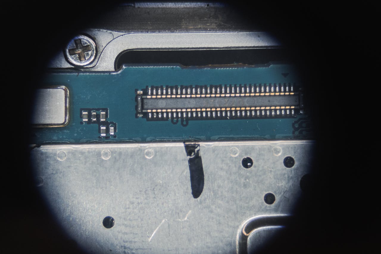 our-experience Detailed macro of an electronic circuit board showing micro components and connections.
